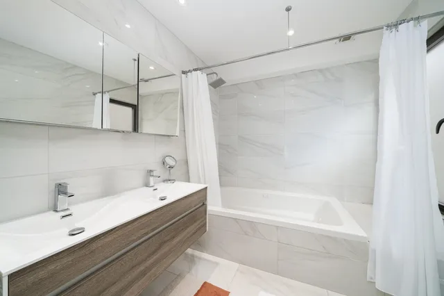 a bathroom with a bathtub and a sink