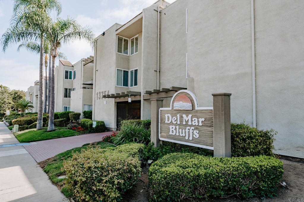 13754 Mango Drive, Unit 218 Del Mar, CA 92014 - Photo 2 of 31 a view of sign board with flower plants