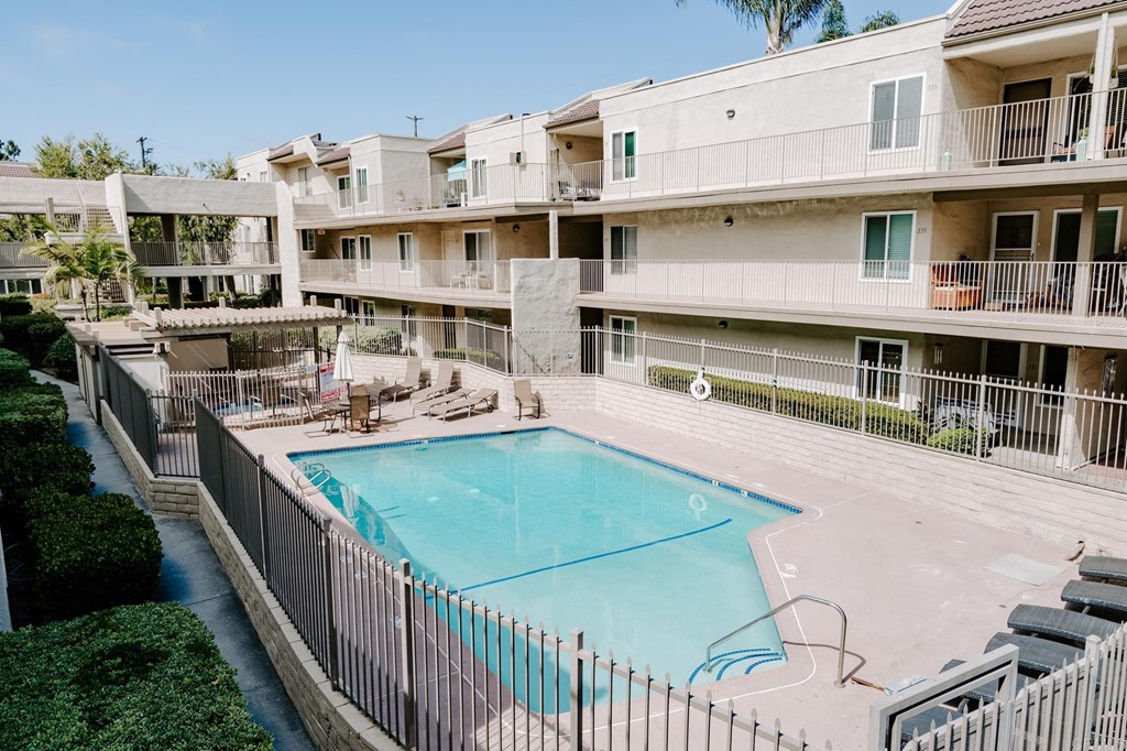 13754 Mango Drive, Unit 218 Del Mar, CA 92014 - Photo 3 of 31 a view of a house with pool and chairs