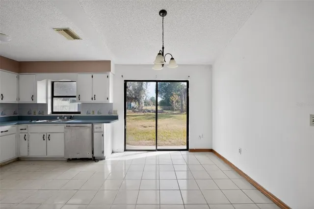 a view of a kitchen with a sink and a window