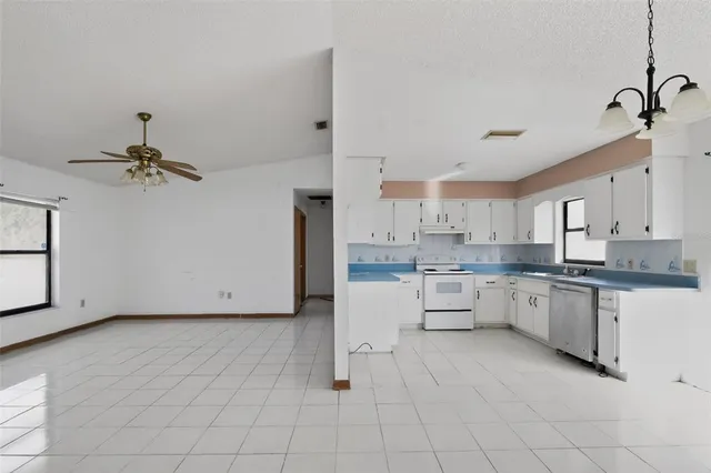 a kitchen with white cabinets and white appliances