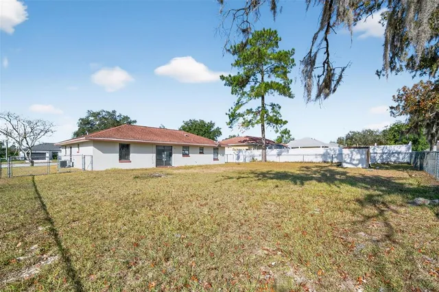 a view of a swimming pool and lounge chairs