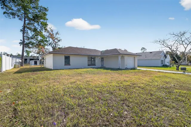 a front view of a house with a garden and yard