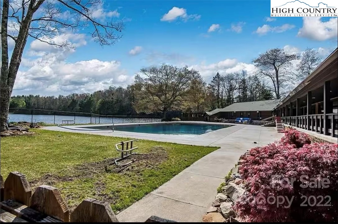 85 Jack Pine Loop Newland, NC 28657 - Photo 23 of 29 a view of a swimming pool with a patio and a yard