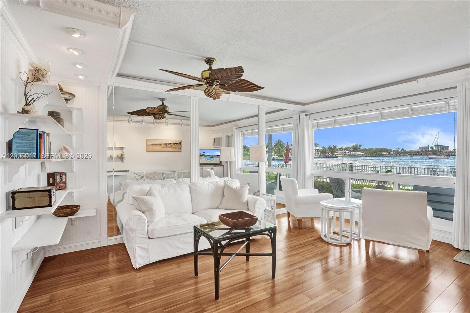 1105 South Riverside Drive, Unit 107 Pompano Beach, FL 33062 - Photo 13 of 31 a living room with furniture a rug and a floor to ceiling window