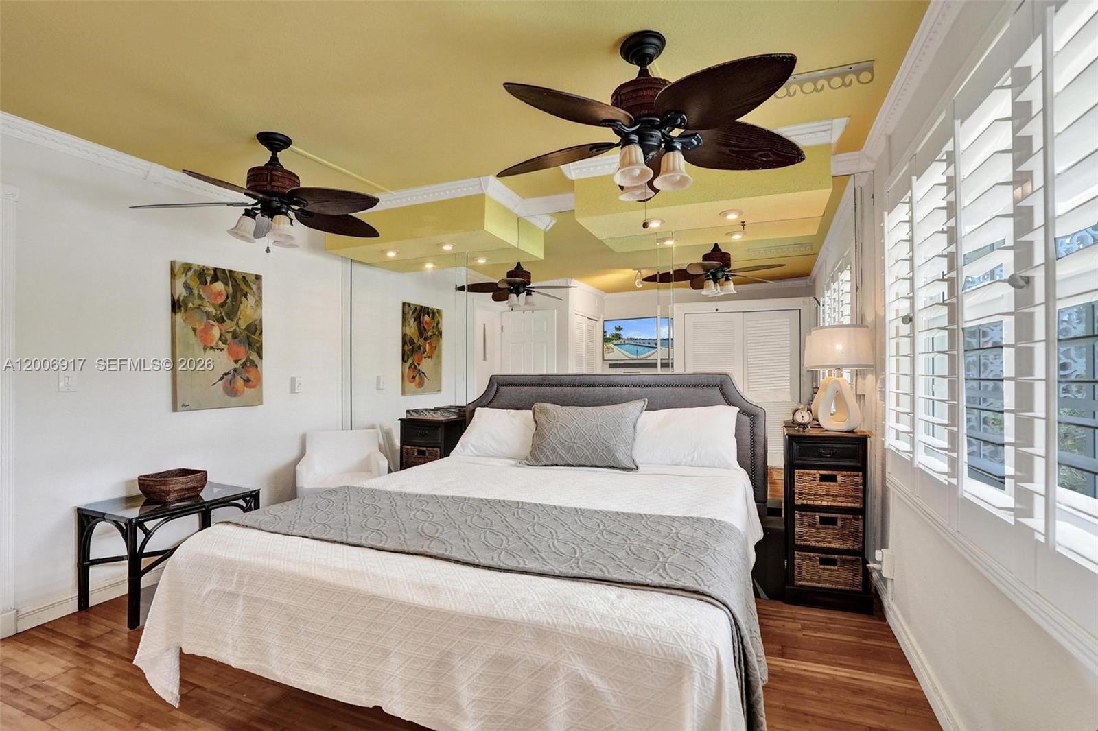 1105 South Riverside Drive, Unit 107 Pompano Beach, FL 33062 - Photo 3 of 31 a bed room with a bed and a chandelier