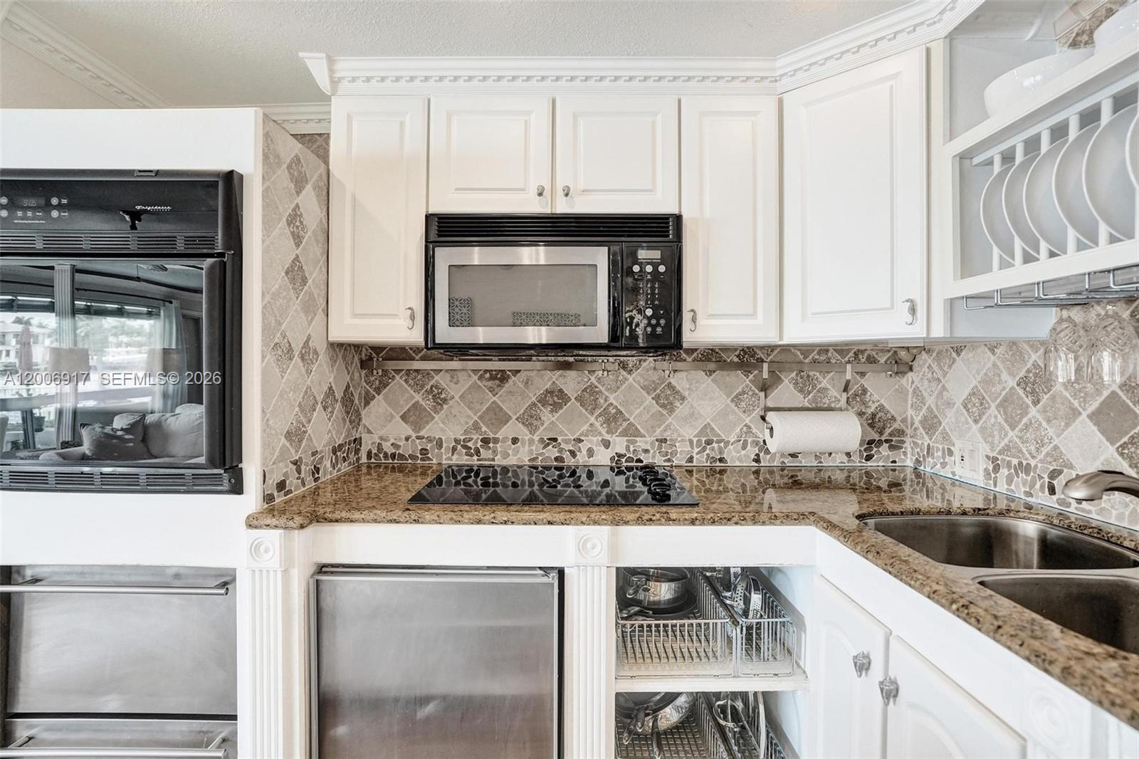 1105 South Riverside Drive, Unit 107 Pompano Beach, FL 33062 - Photo 10 of 31 a kitchen with a sink and cabinets