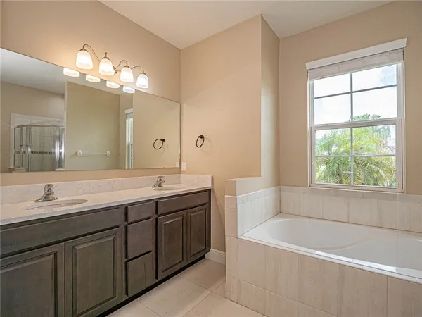 a white bath tub sitting next to a toilet