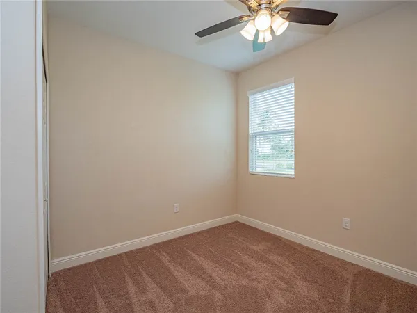 a view of a room with wooden floor and windows