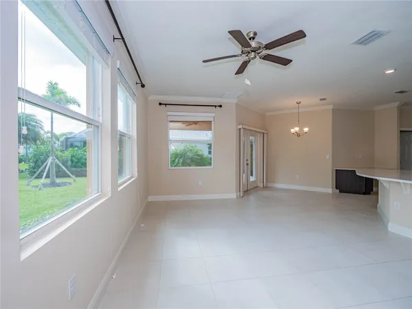 a large kitchen with kitchen island a large counter top stainless steel appliances and cabinets