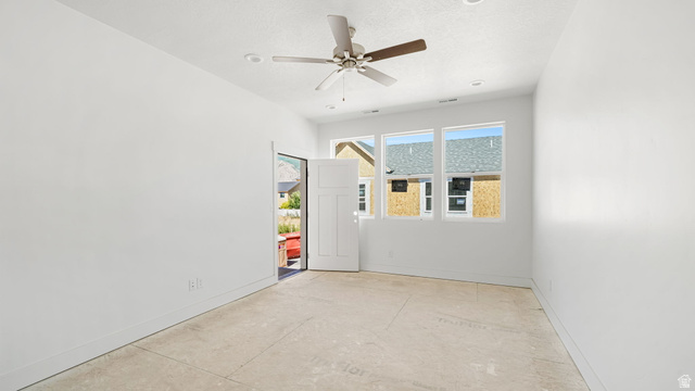 717 South Harrison Drive West Springville, UT 84663 - Photo 11 of 31 Spacious room featuring white walls, a multi-paneled door, and three transom windows