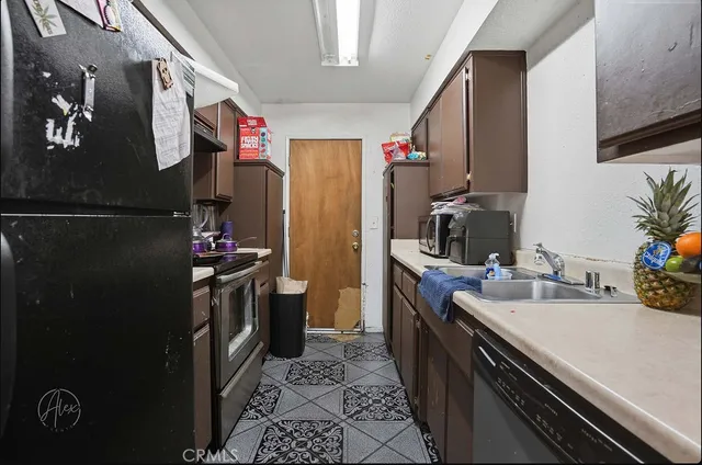 a kitchen with a sink and refrigerator