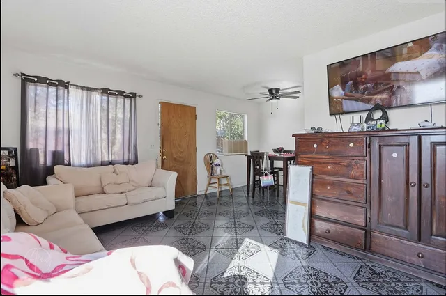 a living room with furniture and a painting on the wall