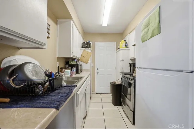a kitchen with a sink appliances and cabinets