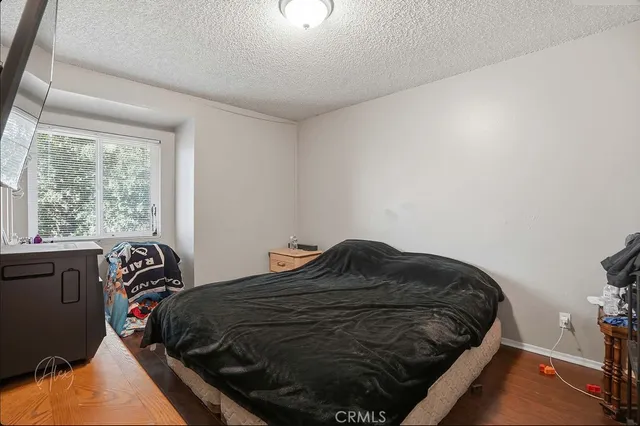a bedroom with a bed next to a window