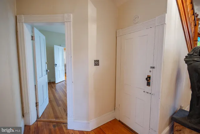 a view of a big room with wooden floor and chandelier