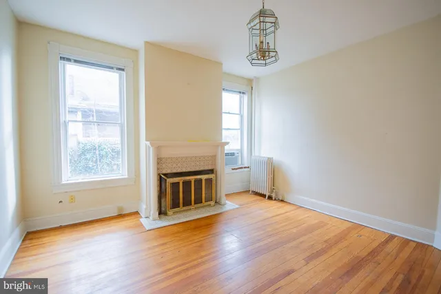 a view of a livingroom with wooden floor and a window