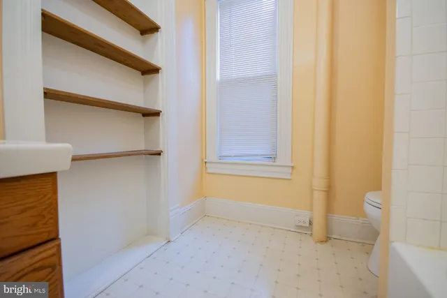 a view of a hallway view with wooden floor and staircase