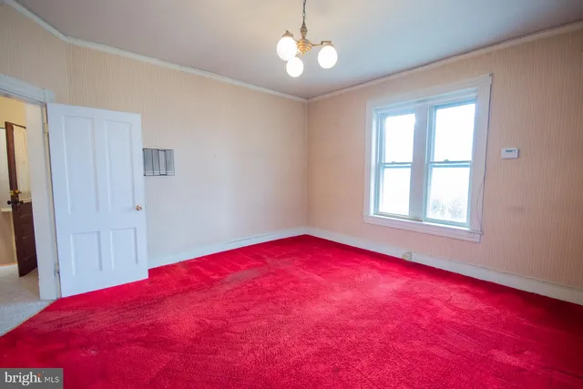 a view of a brick house with large windows and a small yard
