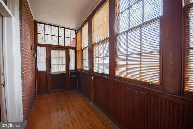 a kitchen with stainless steel appliances granite countertop a refrigerator a sink dishwasher a stove and white countertops with wooden floor