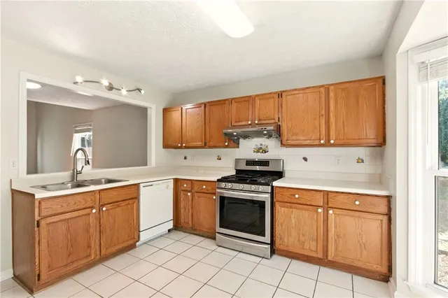a kitchen with a stove sink and cabinets