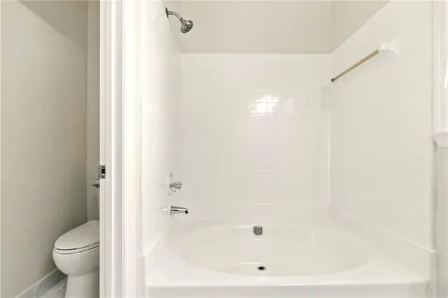 a bathroom with a bathtub and a toilet