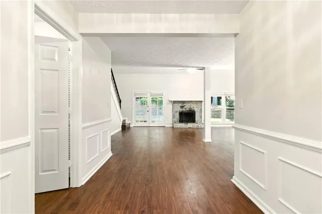 a view of living room with a fireplace and wooden floor