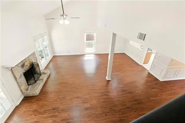 a view of a livingroom with wooden floor and staircase