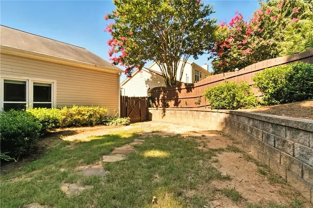 a view of a house with backyard and sitting area