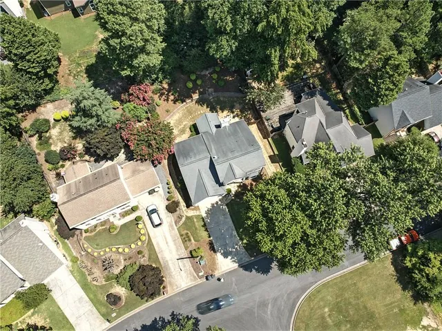 an aerial view of a house with a yard and garden