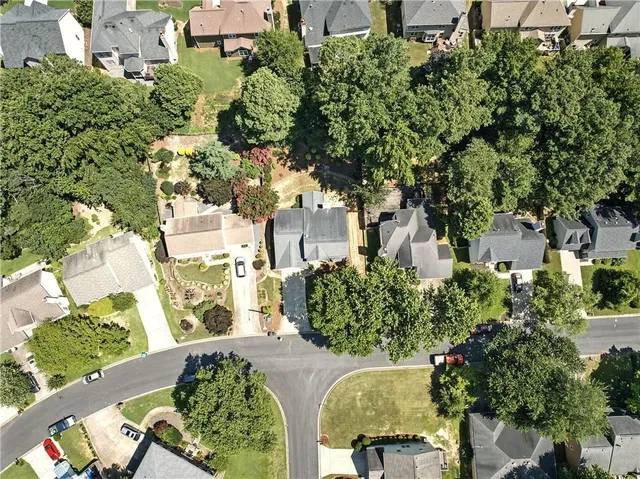 a view of a street with potted plants