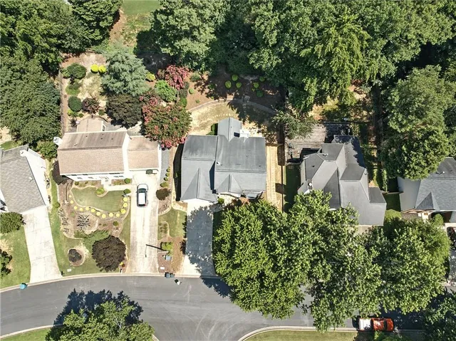 a front view of house with yard and trees in the background