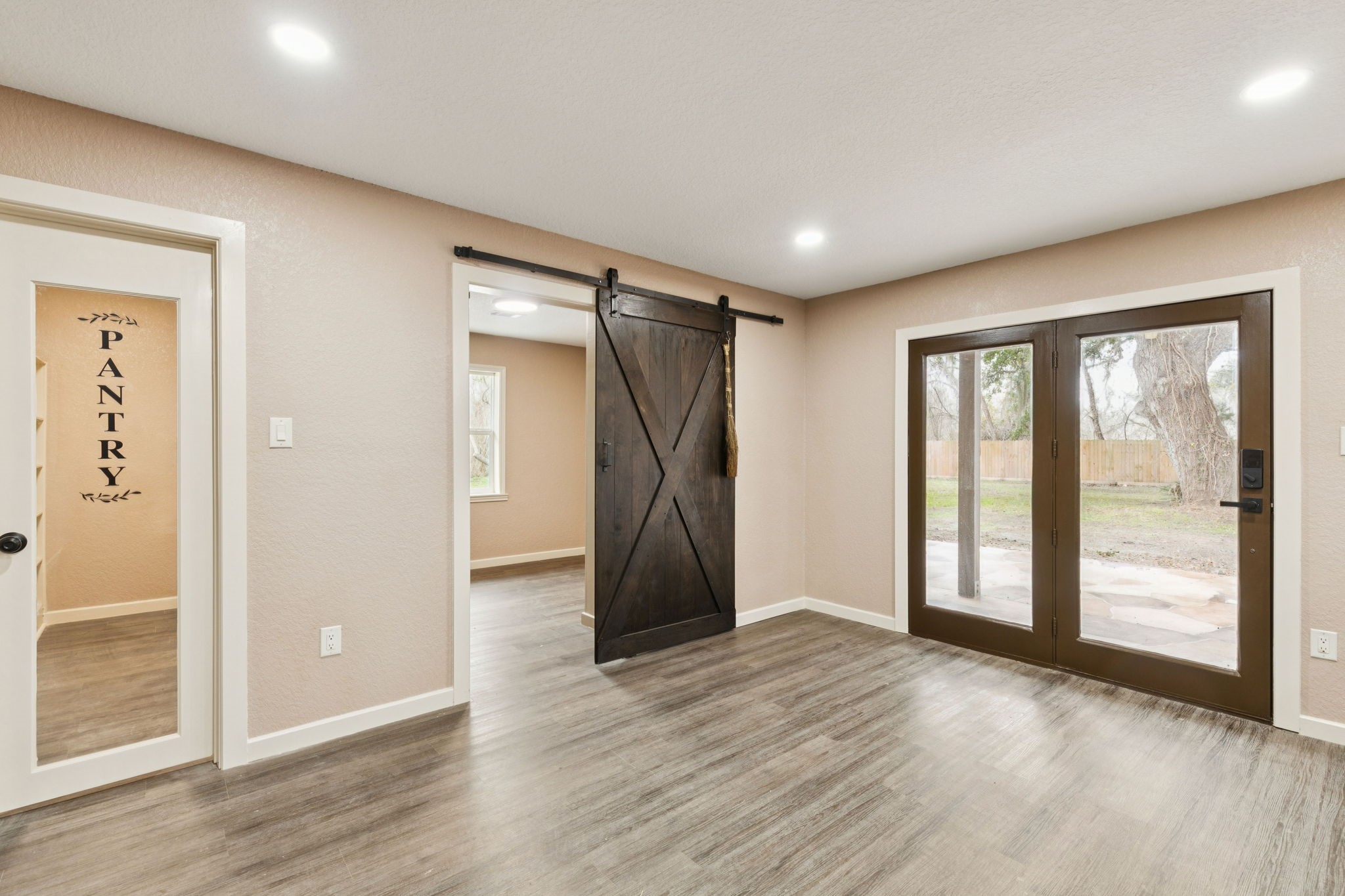 185 Hunters Lane Sweeny, TX 77480 - Photo 5 of 22 an empty room with wooden floor and windows