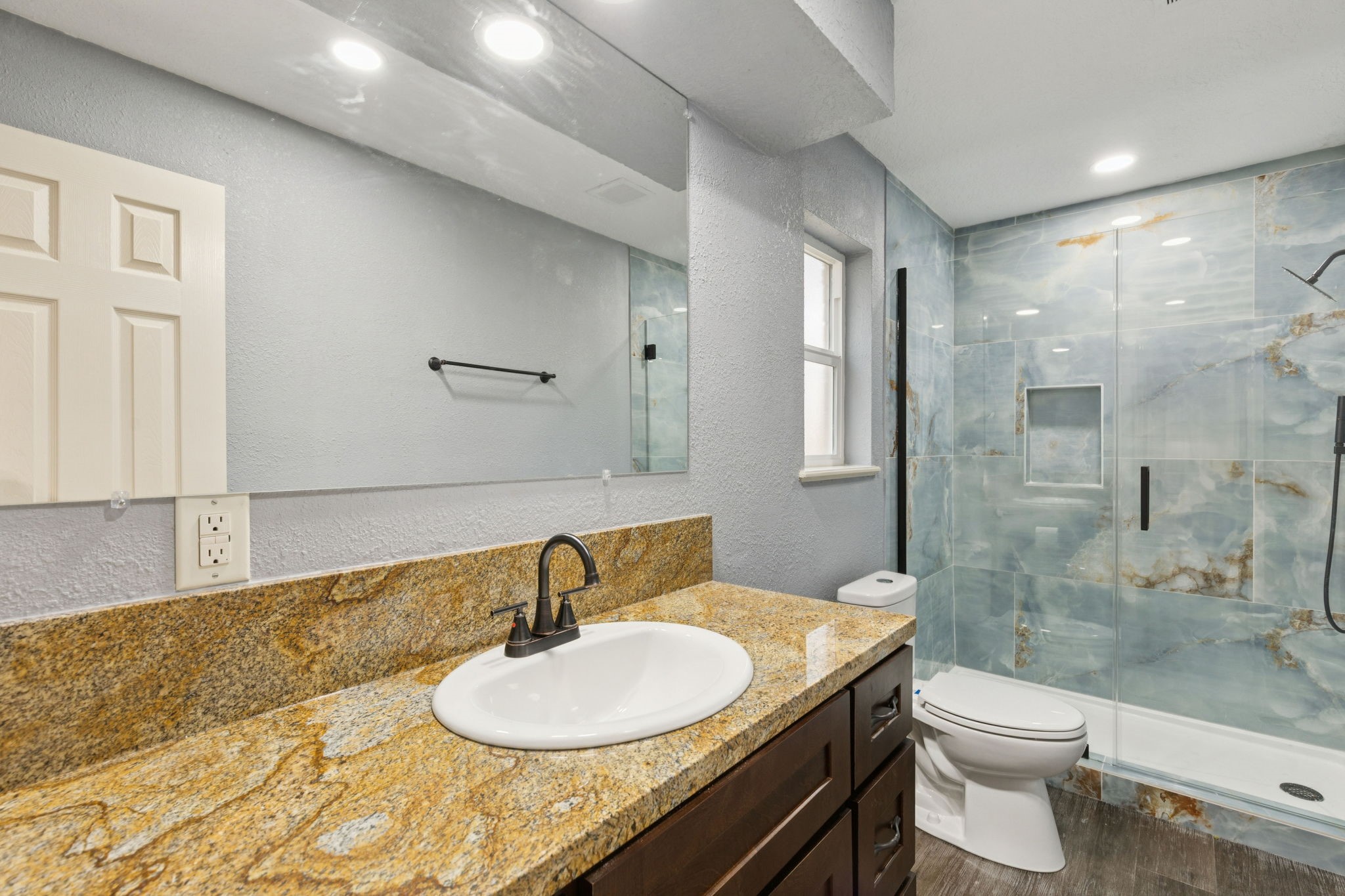 185 Hunters Lane Sweeny, TX 77480 - Photo 9 of 22 a bathroom with a granite countertop sink toilet a mirror and shower