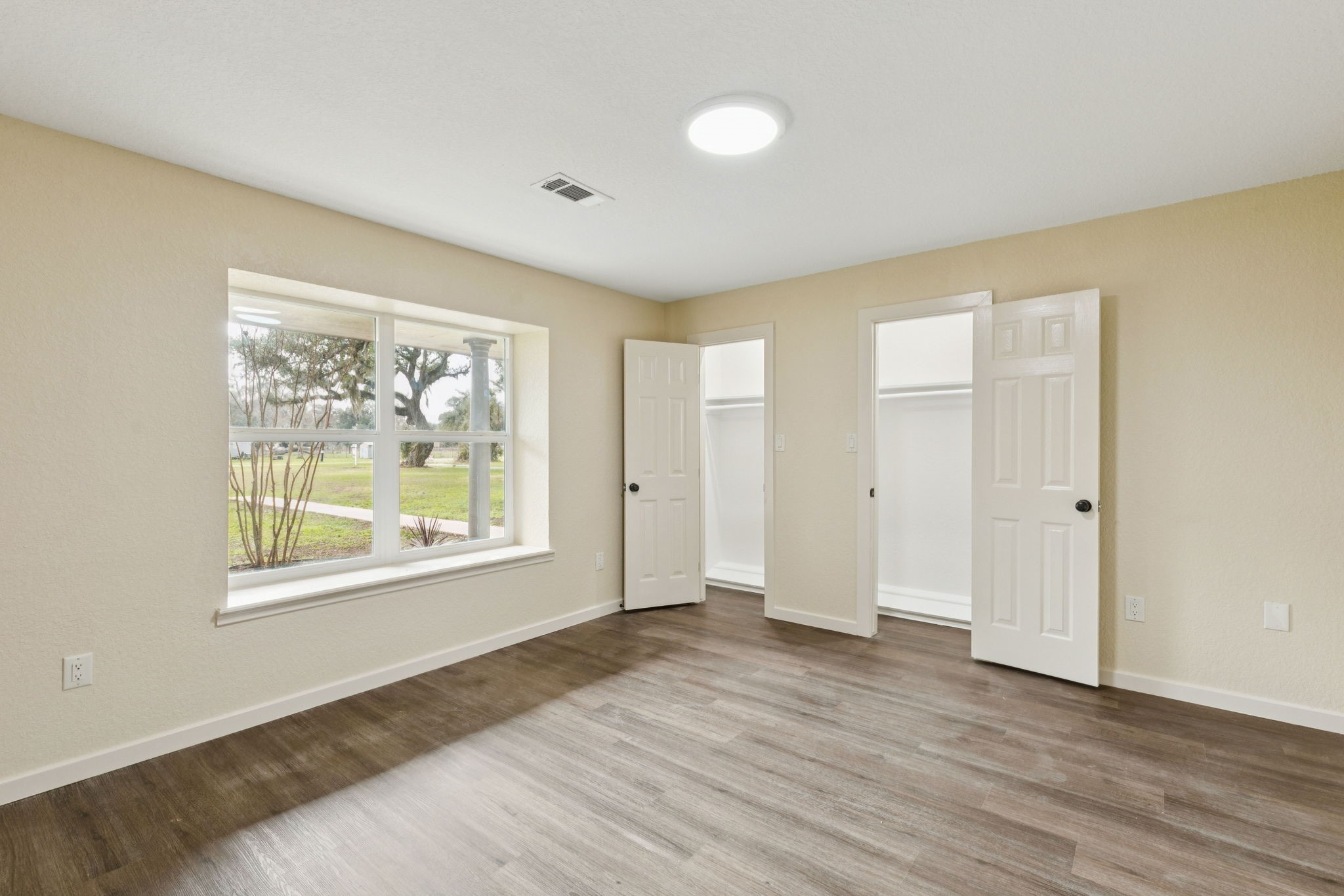 185 Hunters Lane Sweeny, TX 77480 - Photo 10 of 22 a view of an empty room with wooden floor and a window