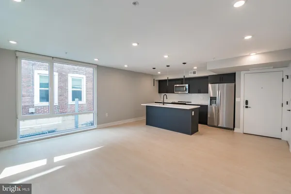 a large kitchen with a stove a sink and a refrigerator
