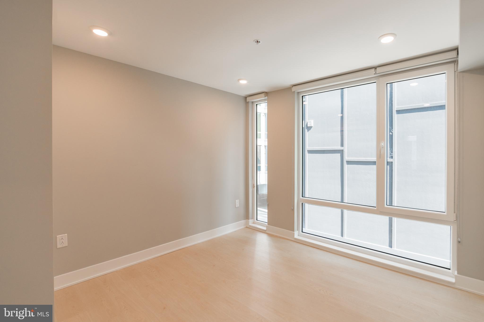 6604 Ridge Avenue, Unit 401 Philadelphia, PA 19128 - Photo 7 of 11 an empty room with windows and closet