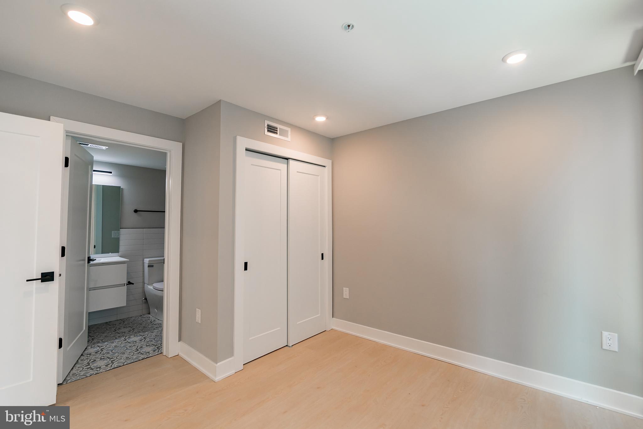 6604 Ridge Avenue, Unit 401 Philadelphia, PA 19128 - Photo 10 of 11 wooden floor in a room with a bathroom