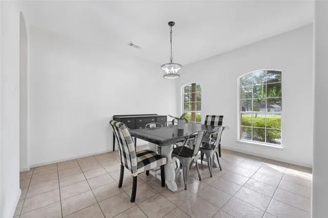 a view of a dining room with furniture and window