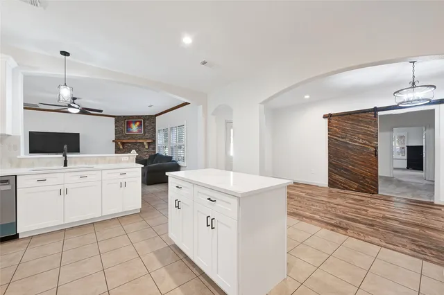 a kitchen with a stove top oven and cabinets