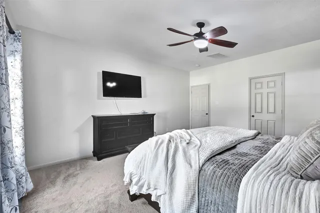 a bed room with a bed and a television