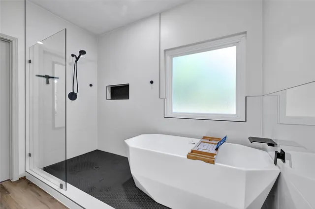 a bathroom with a tub and shower