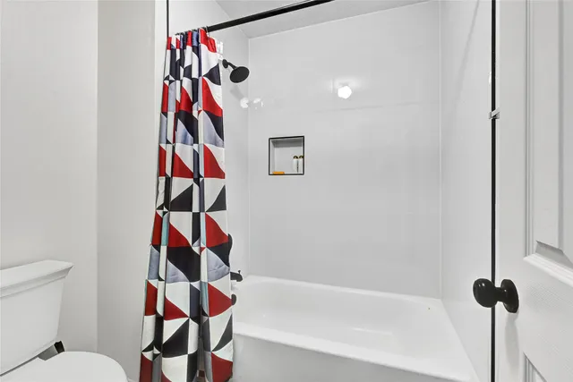 a bathroom with a sink toilet tub and shower