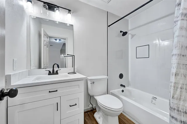 a view of a back yard of the house with a bench