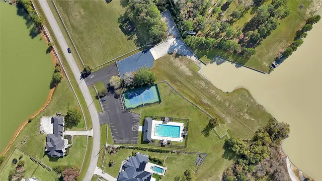 a backyard of a house with lots of green space and fountain