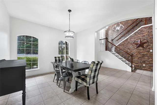 a view of a dining room and livingroom with furniture wooden floor a chandelier