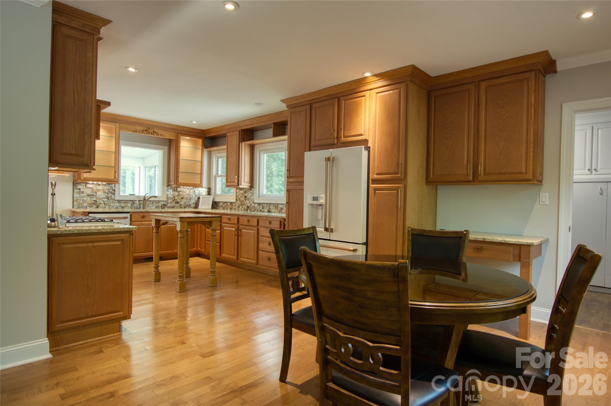 204 Clinton Avenue Clover, SC 29710 - Photo 5 of 26 a kitchen with stainless steel appliances a dining table chairs and granite counter tops