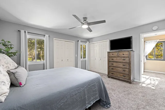 a bedroom with a bed and a television