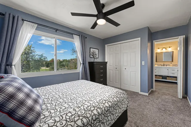 a bedroom with a bed and a large window