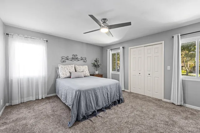 a bedroom with a bed and window